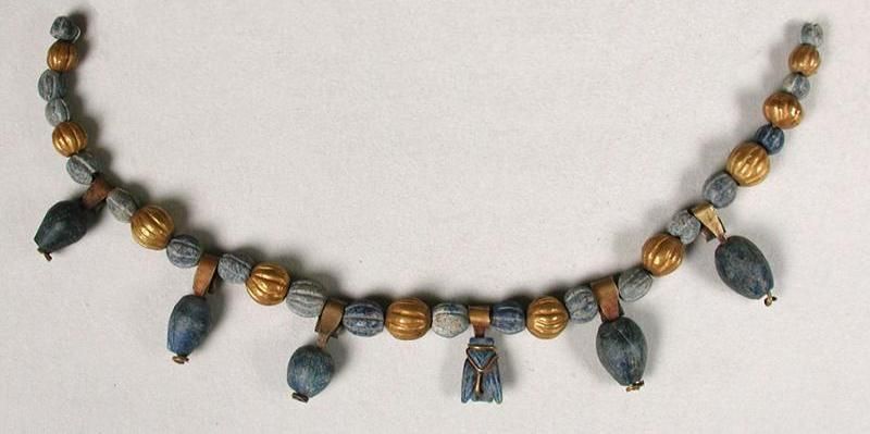 Sumerian necklace with a fly-shaped lapiz lazuli amulet.